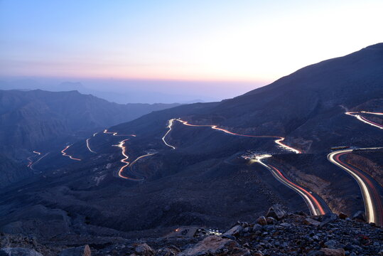 View Of Light Trails On Mountain Road During Dusk