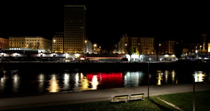 Timelapse of a flowing river in Vienna at night.