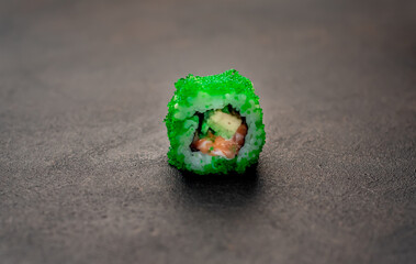 one sushi roll on a stone background