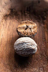 dry brown nutmeg on red wood