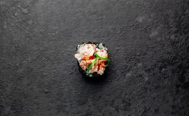 one sushi roll on a stone background