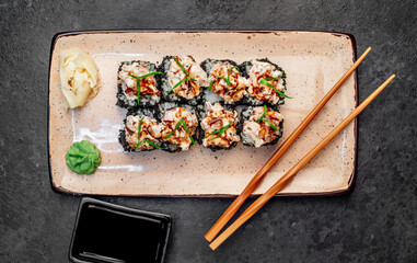 Japanese sushi rolls on a stone background