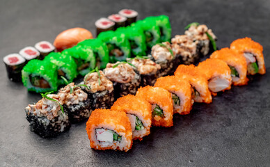 Assorted sushi. set of sushi rolls and nigiri on a stone background