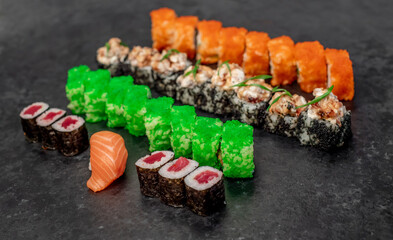 Assorted sushi. set of sushi rolls and nigiri on a stone background