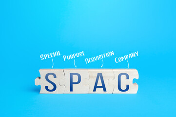Wooden puzzle blocks with abbreviation SPAC (Special purpose acquisition company). Simplified...