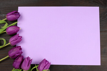 Greeting card with bouquet of tulips on a wooden background, mockup