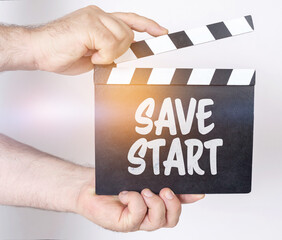 On a white background, a man holds a clapperboard in his hands on which it is written - SAVE START