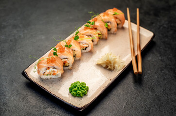  Japanese sushi rolls on a stone background
