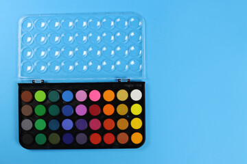 Professional set of watercolor paints with a brush