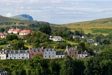 The cityscape of Portree town, Isle of Skye, Scotland at early sunset with typical British houses