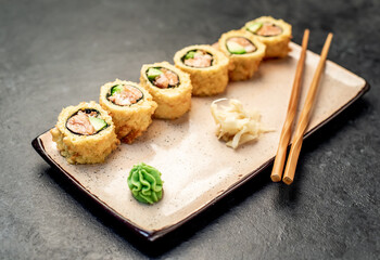 baked sushi rolls on a stone background