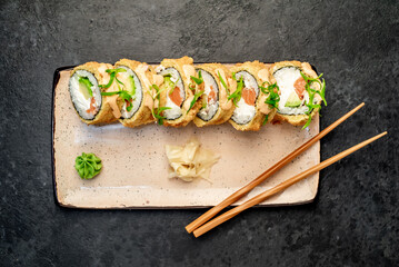 baked sushi rolls on a stone background