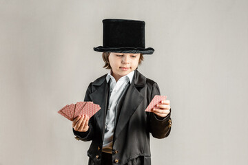 Young boy wearing black suit and a top hat