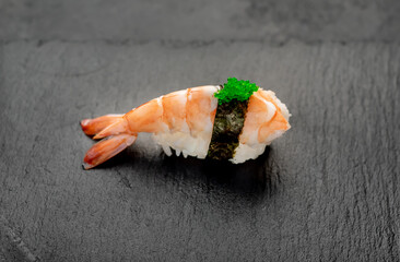 nigiri with shrimp on a stone background