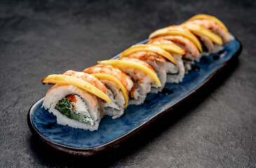 Japanese sushi rolls on a stone background	