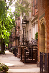 Fototapeta na wymiar Street scene of residential neighborhood with a row of buildings seen from New York City Manhattan