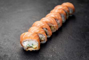 Japanese sushi rolls on a stone background