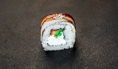 one sushi roll on a stone background