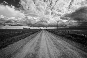 Country road on a cloudy day. - 421337375