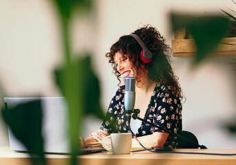 Smiling female content creator streaming at home