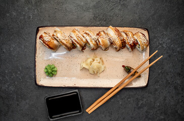 delicious sushi rolls on a stone background