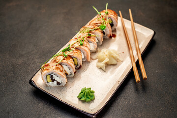 delicious sushi rolls on a stone background