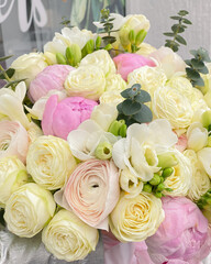 A beautiful bouquet of delicate flowers. White roses combined with pink peonies, ranunculus and spring freesia.