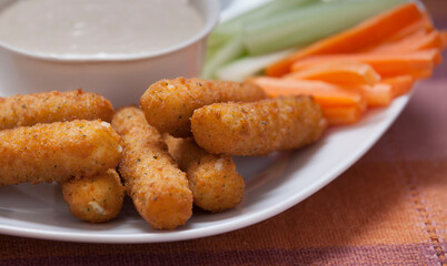 Cheese sticks on a plate with fresh veggies