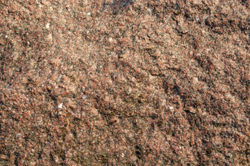 Red black white granite natural texture background. Embossed surface with shadows and stone chips