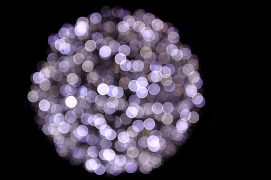 Close-up Of Illuminated Christmas Lights Against Black Background