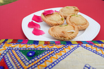 Indian traditional sweet known as Chandrakala, round deep fried sweet from india or Pakistan, eaten and cooked during festivals. Like diwali, holi, ramazan decorated with rose petals.