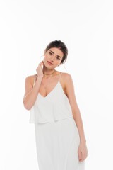 Fototapeta premium sensual woman in wedding dress touching neck while posing isolated on white