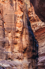 Walls of Siq gorge in Petra historic and archaeological city in southern Jordan