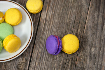 Macarons on a plate on a wooden table