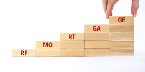 Success remortgage process symbol. Wooden cubes stacking as step stair on white background, copy space. Businessman hand. Word 'remortgage'. Business and remortgage concept.