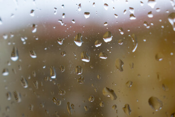 A close-up of raindrops in a window during Winter