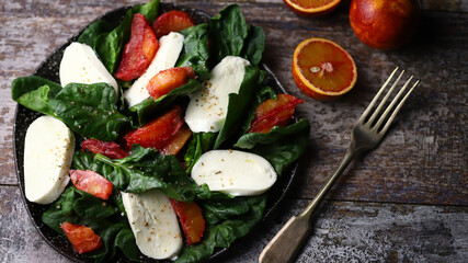 Healthy salad with spinach, mozzarella and red orange. Diet food. Fitness food.