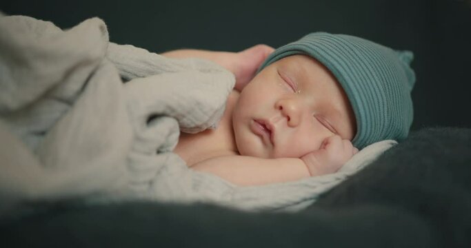 Sleeping newborn baby in plaid