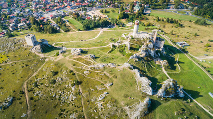 Medieval castle in the village of Olsztyn in the autumn scenery. 
Trail of the Eagles Nests (Szlak Orlich Gniazd). Krakow - Czestochowa Upland. Aerial view.