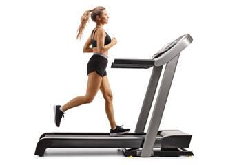 Full length profile shot of a female running on a treadmill