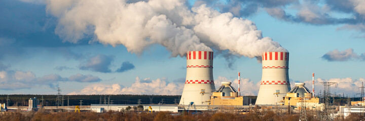 Nuclear power plant with Cooling tower with steam of Atomic power station. Industrial zone of...