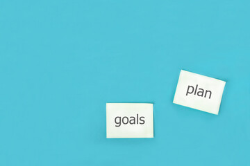 goal, plan, text on office stickers yami. business motivation, idea concept. with free place for text on blue background