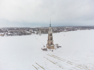 Bell tower in the middle of a frozen lake, top view