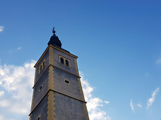 Fototapeta premium Churche tower against blue sky and clouds