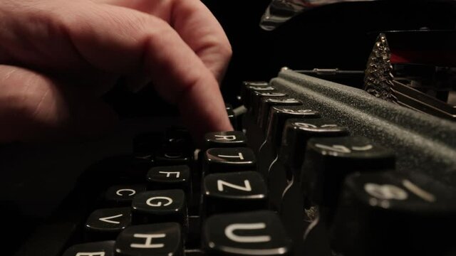 Writing a letter on an old typewriter - very nostalgic - probe lens close up shot