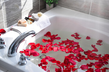 Bathtub filled with red rose petals