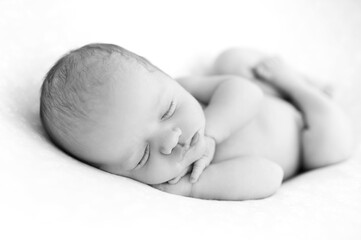 Newborn baby sleeps on blanket. Time to sleep for infant. Hairy baby girl or boy portrait