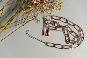 metal chain with a lock and dried flowers