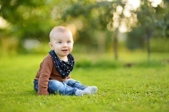 Cute Baby Boy Learning How To Sit Up Without Support. Baby During Floortime. Adorable Little Child Trying To Sit Up On His Own.