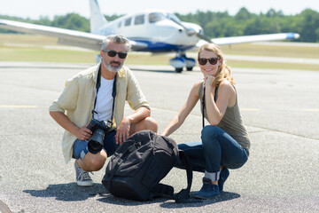 couple looking at camera in the back a lightweight airplane